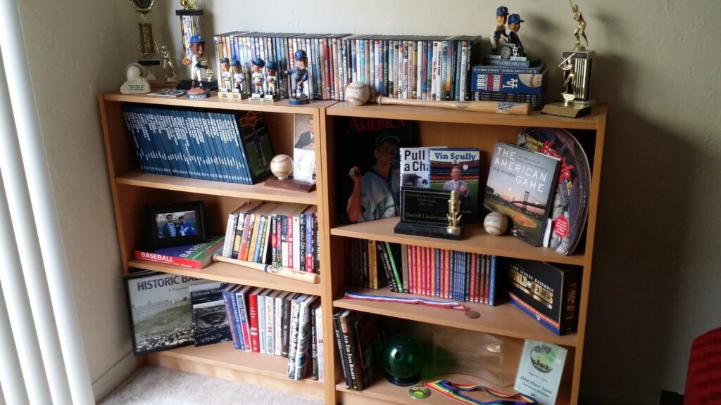 Bookshelf in my bedroom with baseball books, videos and other memorabilia